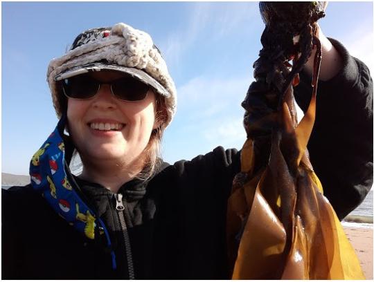 Student holding up kelp